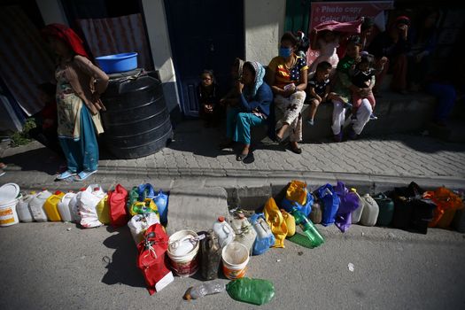 NEPAL, Kathmandu : People wait as they place their empty containers in line to buy kerosene during the ongoing fuel crises that has been continuing for over a month now in Kalikasthan, Kathmandu Kathmandu on November, 3 2015. Amid the dispute over new controversial constitution of Nepal, fuel exports from India have halted, creating an escalating emergency situation. 