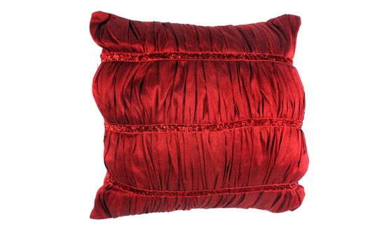 A luxurious red pillow made of soft satin, on white studio background