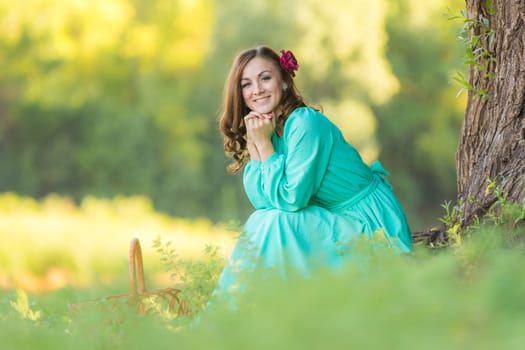 The young beautiful girl walks through the forest on a warm summer day