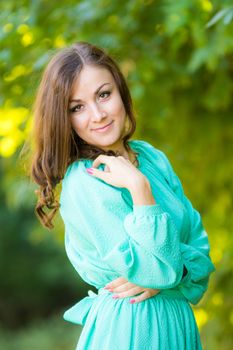 The young beautiful girl walks through the forest on a warm summer day