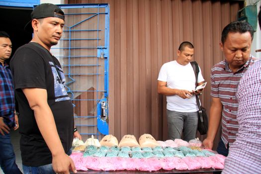 INDONESIA, Medan: Police detectives reveal at a conference that they have busted drug dealers from an international network in the city of Medan, Indonesia on November 3, 2015. A wide array of contraband are on display, reportedly including 12 kg of methamphetamine and 37,000 ecstasy pills, along with scales and weapons. The drugs on display are believed to be of Chinese origin, and the suspect is thought to have been operating in the area for at least six months.