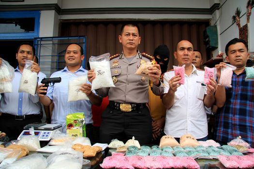 INDONESIA, Medan: Police detectives reveal at a conference that they have busted drug dealers from an international network in the city of Medan, Indonesia on November 3, 2015. A wide array of contraband are on display, reportedly including 12 kg of methamphetamine and 37,000 ecstasy pills, along with scales and weapons. The drugs on display are believed to be of Chinese origin, and the suspect is thought to have been operating in the area for at least six months.