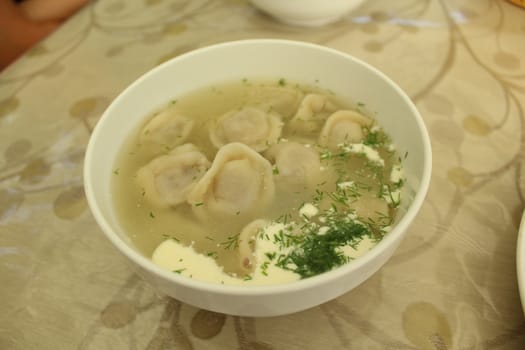 Meat dumplings with crushed herbs on top.