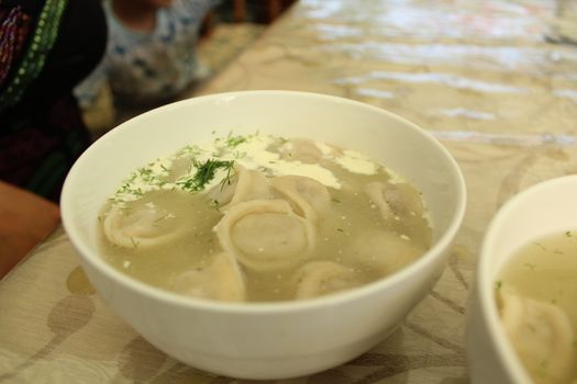 Meat dumplings with crushed herbs on top.