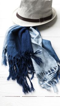 hat and blue scarf on white table