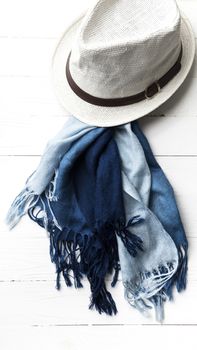 hat and blue scarf on white table