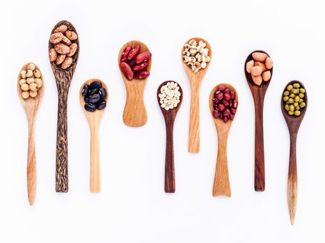 Assortment of beans and lentils in wooden spoon isolate on white  background. mung bean, groundnut, soybean, red kidney bean , black bean ,red bean and brown pinto beans .