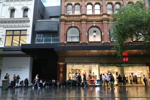 AUSTRALIA, Sydney: A queue forms outside the H&M store in Pitt Street Mall, Sydney on November 4, 2015 ahead of the official launch of the Balmain X H&M fashion range on November 5, 2015.