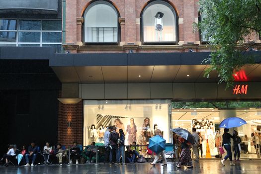 AUSTRALIA, Sydney: A queue forms outside the H&M store in Pitt Street Mall, Sydney on November 4, 2015 ahead of the official launch of the Balmain X H&M fashion range on November 5, 2015.