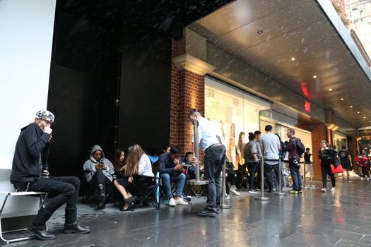 AUSTRALIA, Sydney: A queue forms outside the H&M store in Pitt Street Mall, Sydney on November 4, 2015 ahead of the official launch of the Balmain X H&M fashion range on November 5, 2015.