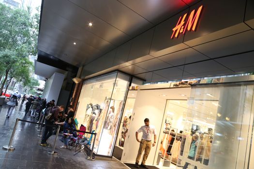 AUSTRALIA, Sydney: A queue forms outside the H&M store in Pitt Street Mall, Sydney on November 4, 2015 ahead of the official launch of the Balmain X H&M fashion range on November 5, 2015.