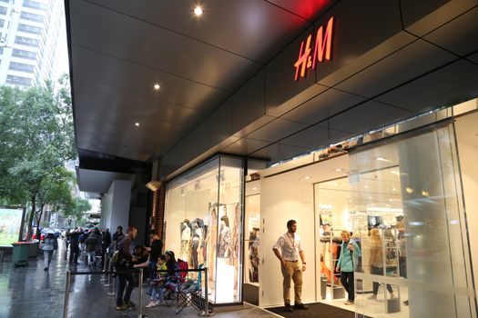 AUSTRALIA, Sydney: A queue forms outside the H&M store in Pitt Street Mall, Sydney on November 4, 2015 ahead of the official launch of the Balmain X H&M fashion range on November 5, 2015.