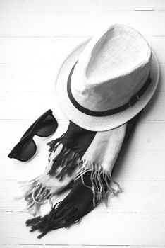 hat and blue with sunglasses scarf on white table black and white color