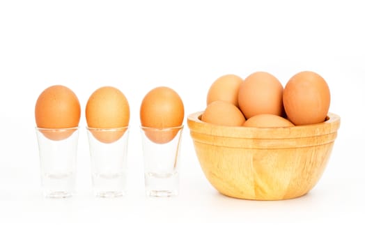 Fresh eggs in a bowl on white background