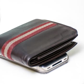 brown wallet and smartphone isolated white background on table