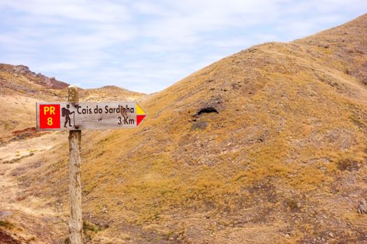 Signpost showing the way to Cais do Sardinha, a famous walk trail for hikers on island of Madeira.