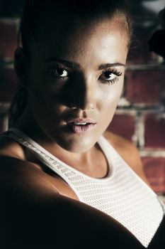 Female fitness model posing in studio. Cinematic Portrait Style.