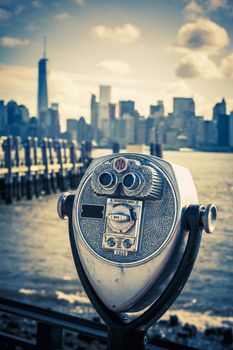 Tourist binoculars at Liberty Island in front of Manhattan Skyline, vintage style, New York City, USA