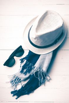 hat and blue with sunglasses scarf on white table vintage style