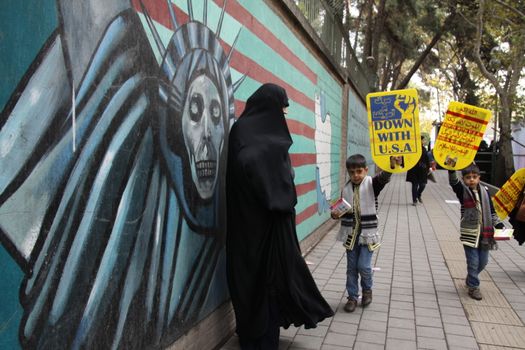IRAN, Tehran: Boys hold placards which read 'Down with USA' as hundreds of people march in front of the former US embassy in Tehran, during the '13 Aban' (4th of November in english), on November 4, 2015, to commemorate the anniversary of the 1979 US embassy taking.