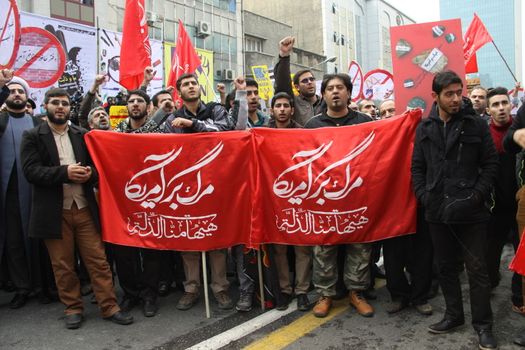 IRAN, Tehran: Protesters hold flags which read 'Down with USA' as hundreds of people march in front of the former US embassy in Tehran, during the '13 Aban' (4th of November in english), on November 4, 2015, to commemorate the anniversary of the 1979 US embassy taking.