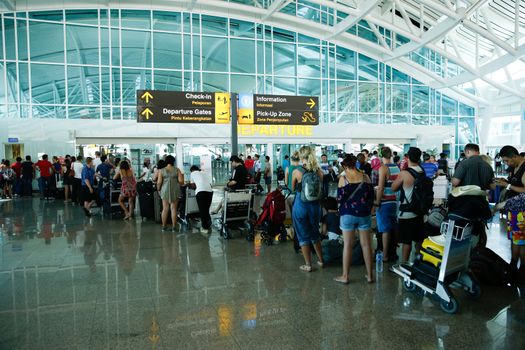INDONESIA, Denpasar: Passengers wait for information on delayed and cancelled flights at the international departure area of Bali's Ngurah Rai Airport in Denpasar on November 4, 2015. Indonesia will extend the closure of an international airport on popular Bali resort island to on November 5 due to ash from an erupting volcano, an official said on November 4, grounding more than 100 flights. 
