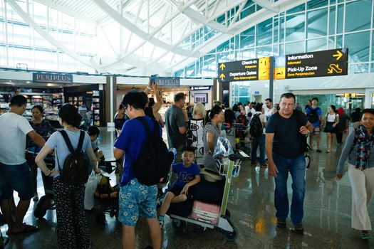 INDONESIA, Denpasar: Passengers wait for information on delayed and cancelled flights at the international departure area of Bali's Ngurah Rai Airport in Denpasar on November 4, 2015. Indonesia will extend the closure of an international airport on popular Bali resort island to on November 5 due to ash from an erupting volcano, an official said on November 4, grounding more than 100 flights. 