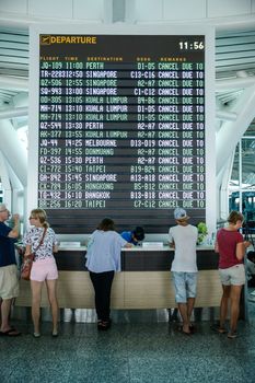 INDONESIA, Denpasar: Passengers wait for information on delayed and cancelled flights at the international departure area of Bali's Ngurah Rai Airport in Denpasar on November 4, 2015. Indonesia will extend the closure of an international airport on popular Bali resort island to on November 5 due to ash from an erupting volcano, an official said on November 4, grounding more than 100 flights. 