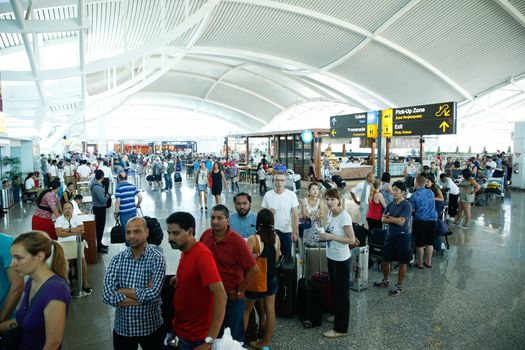 INDONESIA, Denpasar: Passengers wait for information on delayed and cancelled flights at the international departure area of Bali's Ngurah Rai Airport in Denpasar on November 4, 2015. Indonesia will extend the closure of an international airport on popular Bali resort island to on November 5 due to ash from an erupting volcano, an official said on November 4, grounding more than 100 flights. 