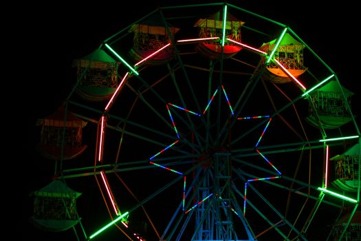 Colorful ferris wheel at night amusement park