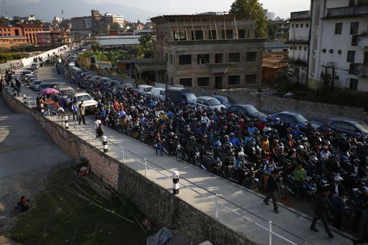 NEPAL, Kathmandu: Motorists wait in a queue for petrol near a petrol station in Kathmandu on November 4, 2015. Nepal signed a deal last week with China to import petroleum products, its embassy in Beijing said, as the Himalayan nation tries to boost supplies to deal with a deepening fuel crisis. The curfew imposed in Birgunj, Nepal after violent protests where one person was killed near the Shankaracharya Gate close to the Nepal-India border on Monday causing tight security for goods to arrive.