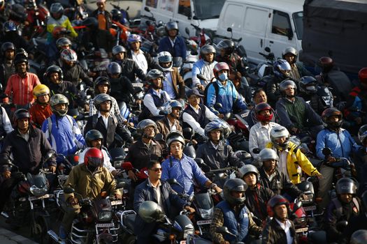 NEPAL, Kathmandu: Motorists wait in a queue for petrol near a petrol station in Kathmandu on November 4, 2015. Nepal signed a deal last week with China to import petroleum products, its embassy in Beijing said, as the Himalayan nation tries to boost supplies to deal with a deepening fuel crisis. The curfew imposed in Birgunj, Nepal after violent protests where one person was killed near the Shankaracharya Gate close to the Nepal-India border on Monday causing tight security for goods to arrive.