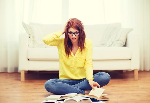 education concept - stressed student girl reading books at home