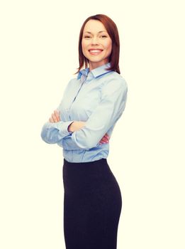 business and education concept - friendly young smiling businesswoman with crossed arms