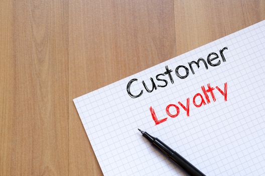 Customer loyalty text concept write on notebook