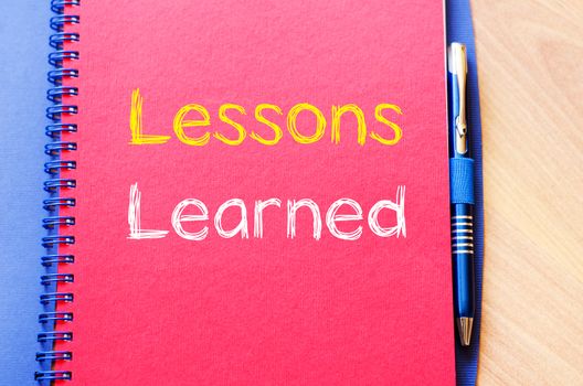 Lessons learned text concept write on notebook
