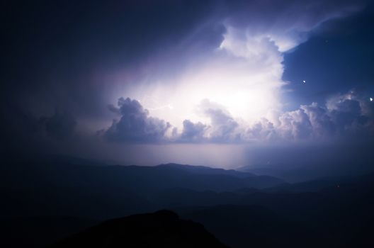 Carpathian Mountains. Mount Pop Ivan. Thunderhead and the starry sky above the ridge Montenegrin