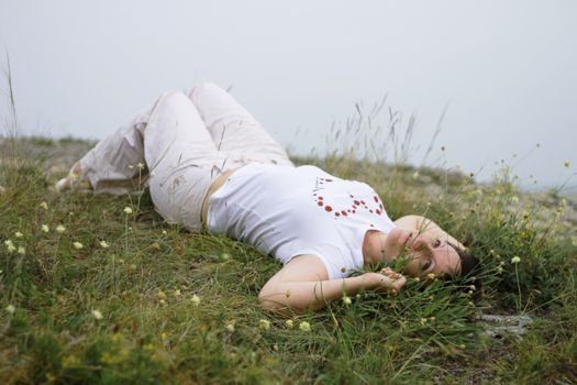 Woman laying in the grass on the meadow