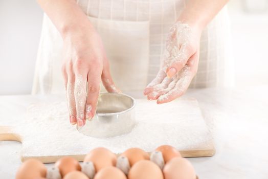 Woman hands Making donuts on Kitchen Board. Close-up.