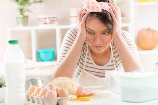 Frustrated Young woman making dough