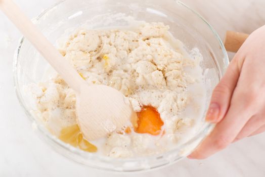 Making dough with mixing spoon. Close-up.