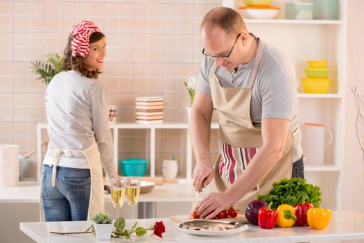 Happy couple preparing food in the kitchen