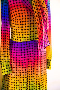 Detail of a vintage dress with a pattern of colored dots.