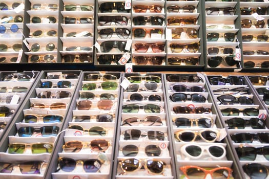 Stall exhibits many colorful vintage sunglasses 70s.