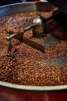 Freshly roasted coffee beans in a coffee roaster. Shallow dof