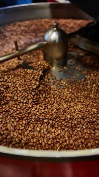 Freshly roasted coffee beans in a coffee roaster. Shallow dof