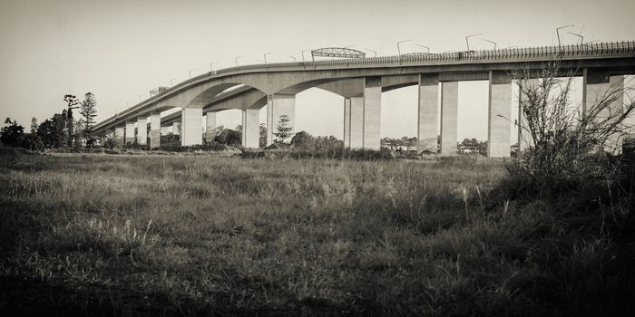 The Gateway Bridge (Sir Leo Hielscher Bridges) at sunset in Brisbane, Queensland, Australia. Abstract black and white image.