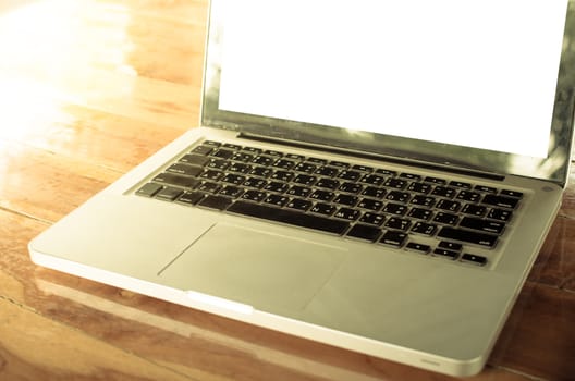 laptop computer on wooden desk as concept with overcast effect