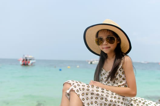 Portrait of funny little girl on sea