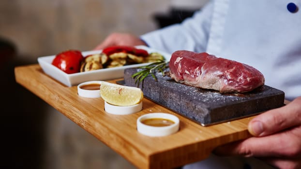 meat grilled on a stone with vegetables on the plate